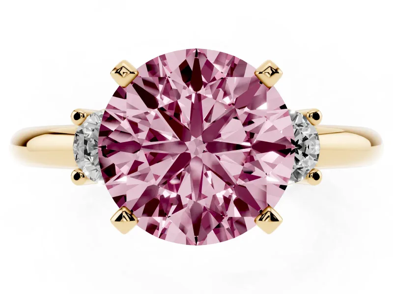 Fancy Pink Three-Stone Round Cut Diamond Ring Set in Yellow gold with Prong Setting and Plain Band