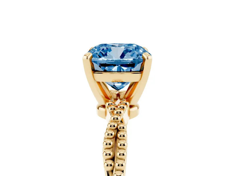 Fancy Blue Cushion Cut Diamond Solitaire Ring Set in Yellow gold with Twisted Band and Bead Prong Setting