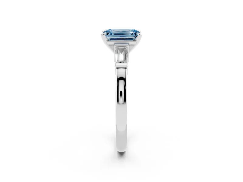 Fancy Blue Emerald Cut Diamond Solitaire Ring Set in Silver with Tapered Baguette Accents and Prong Setting