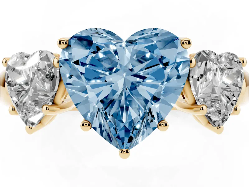 Fancy Blue Heart Cut Diamond Three-Stone Ring Set in Yellow gold with Bold Center and Classic Band