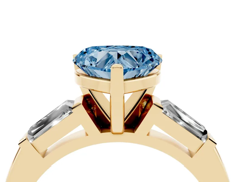 Fancy Blue Heart Cut Diamond Solitaire Ring Set in Yellow gold with Tapered Baguette Side Stones and Prong Setting