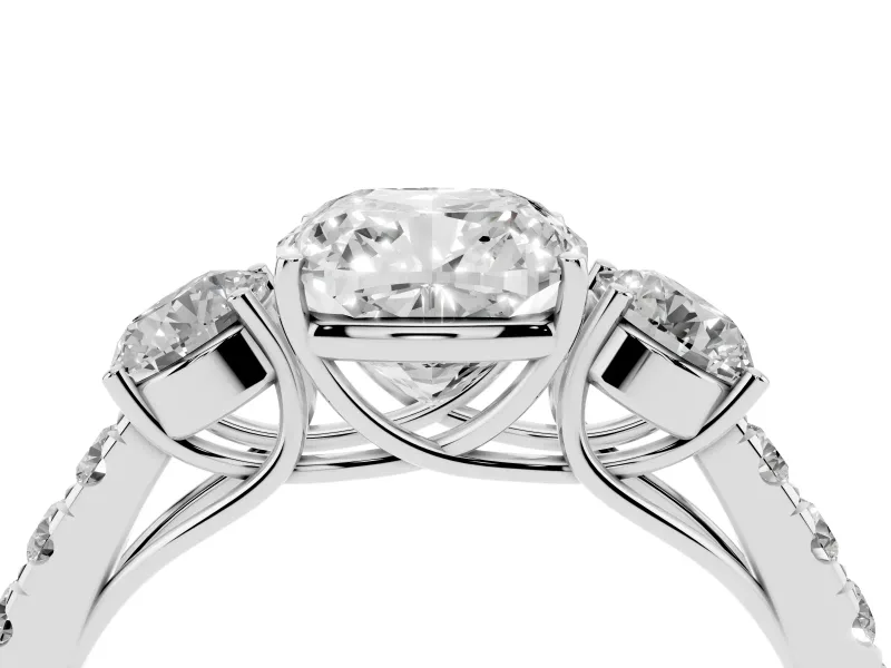Cushion Cut Diamond Three-Stone Ring Set in Platinum with Round Side Stones and Delicate Pavé Band