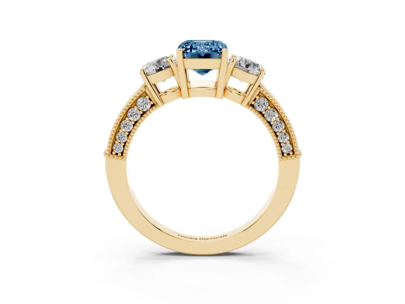 Fancy Blue Emerald Cut Diamond Three-Stone Ring Set in Yellow gold with Round Side Stones and Pavé Band