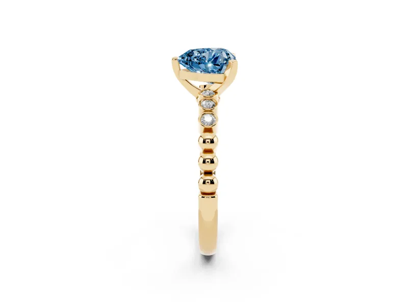 Fancy Blue Heart Cut Diamond Solitaire Engagement Ring Set in Yellow gold with Bezel Accents on Beaded Band