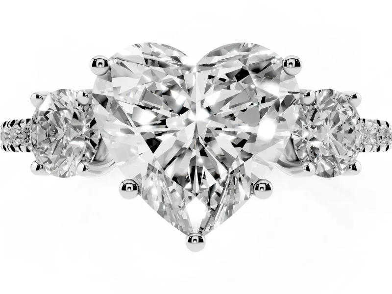 Heart Cut Diamond Three-Stone Ring Set in Platinum with Pavé Band and Graduated Sides
