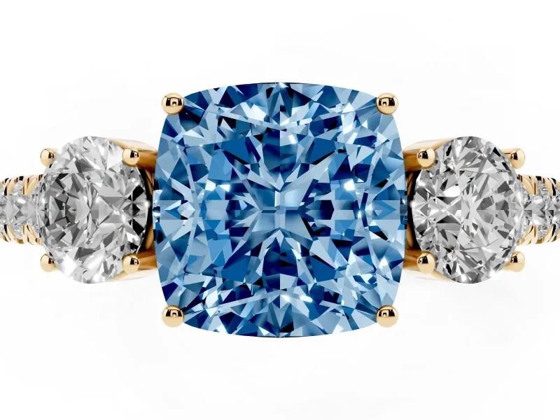 Fancy Blue Cushion Cut Diamond Three-Stone Ring Set in Yellow gold with Round Side Stones and Delicate Pavé Band