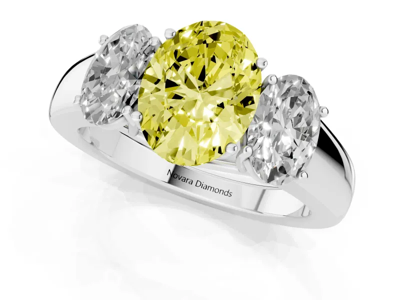 Fancy Yellow Three-Stone Oval Cut Diamond Ring Set in Platinum with Matching Prong Settings and Plain Band