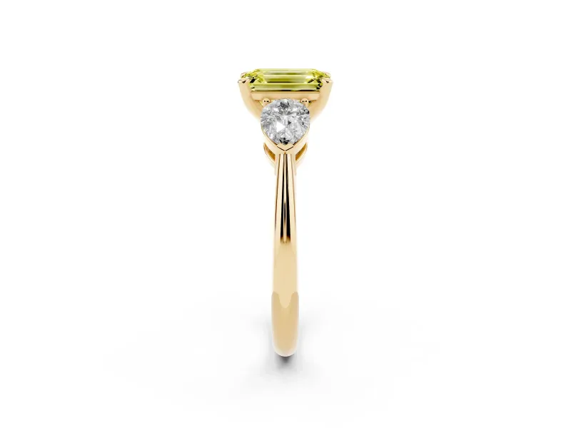 Fancy Yellow Three-Stone Emerald Cut Diamond Ring Set in Yellow gold with Pear Side Stones and Prong Setting