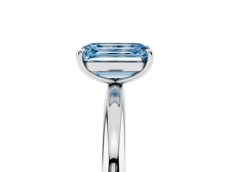 Fancy Blue Emerald Cut Diamond Solitaire Ring Set in Silver with Prong Setting on a Polished Plain Band