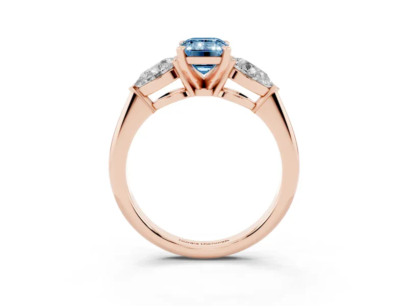 Fancy Blue Three-Stone Emerald Cut Diamond Ring Set in Rose gold with Pear Side Stones and Prong Setting
