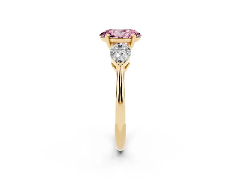 Fancy Pink Three-Stone Oval Cut Diamond Ring Set in Yellow gold with Pear Side Stones and Prong Setting