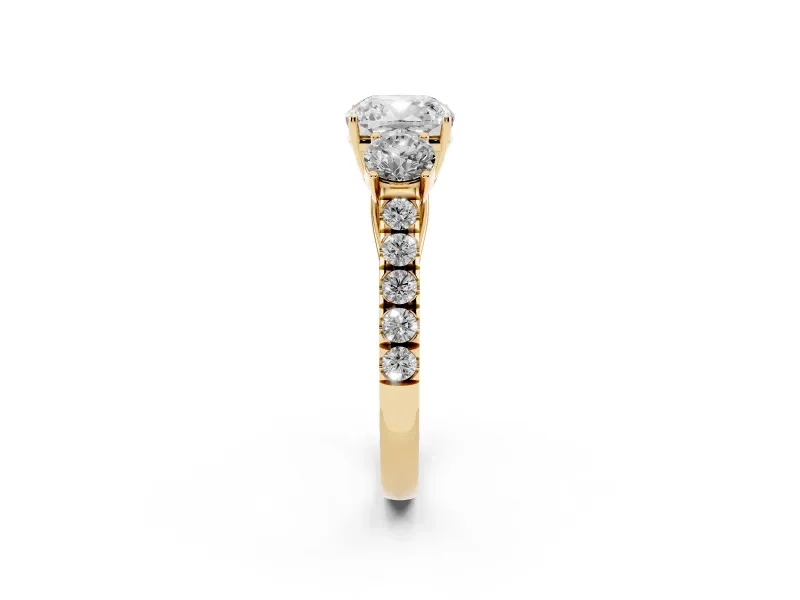 Cushion Cut Diamond Three-Stone Ring Set in Yellow gold with Round Side Stones and Delicate Pavé Band