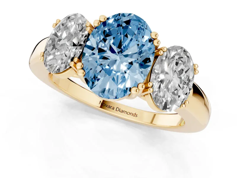 Fancy Blue Oval Cut Diamond Three-Stone Ring Set in Yellow gold with Polished Band and Prong Setting
