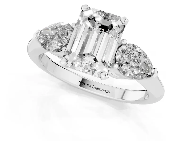 Three-Stone Emerald Cut Diamond Ring Set in Platinum with Pear Side Stones and Prong Setting