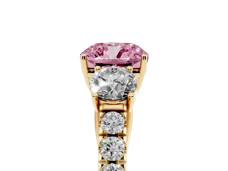 Fancy Pink Cushion Cut Diamond Three-Stone Ring Set in Yellow gold with Round Side Stones and Delicate Pavé Band