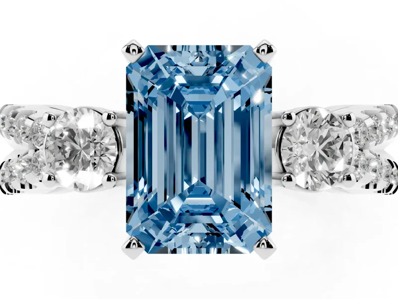 Fancy Blue Emerald Cut Diamond Three-Stone Ring Set in Platinum with Pavé Split Shank and Prong Setting