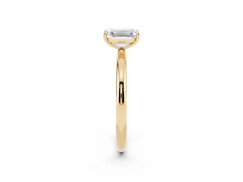 Emerald Cut Diamond Solitaire Ring Set in Yellow gold with Prong Setting on a Polished Plain Band