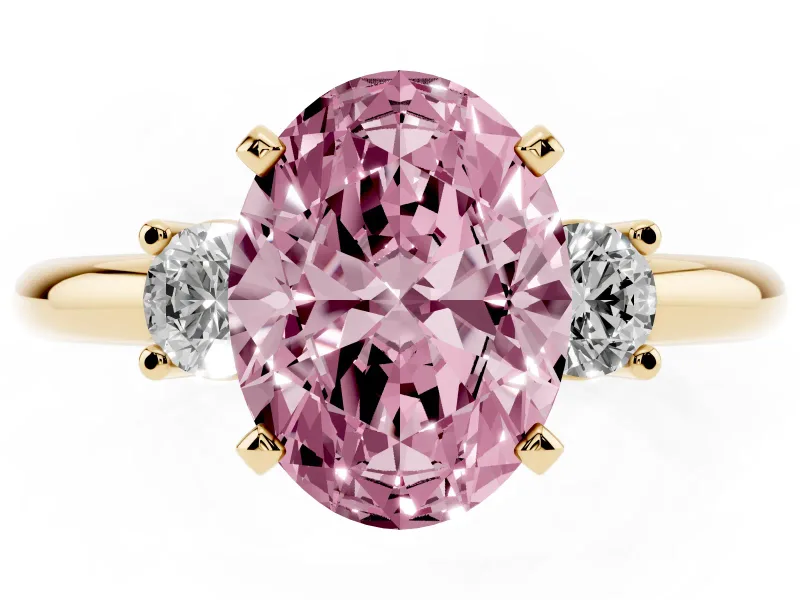Fancy Pink Three-Stone Oval Cut Diamond Ring Set in Yellow gold with Prong Setting and Plain Band