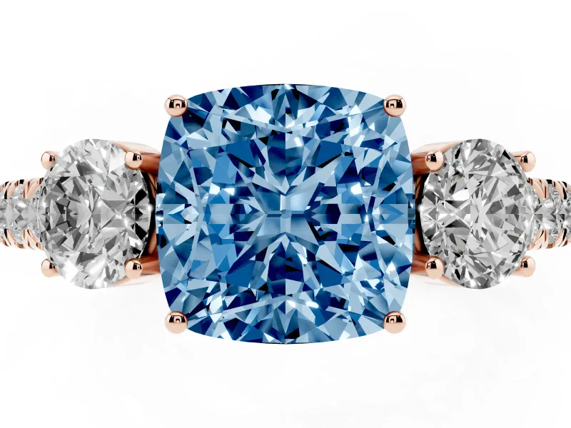 Fancy Blue Cushion Cut Diamond Three-Stone Ring Set in Rose gold with Round Side Stones and Delicate Pavé Band