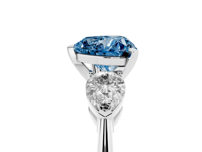 Fancy Blue Three-Stone Heart Cut Diamond Ring Set in White gold with Pear Side Stones and Prong Setting