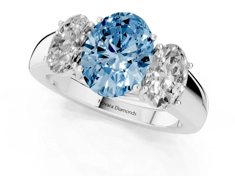 Fancy Blue Three-Stone Oval Cut Diamond Ring Set in Platinum with Matching Prong Settings and Plain Band