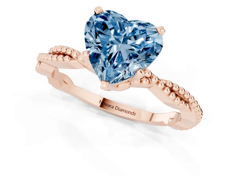 Fancy Blue Heart Cut Diamond Solitaire Ring Set in Rose gold with Twisted Band and Bead Prong Setting