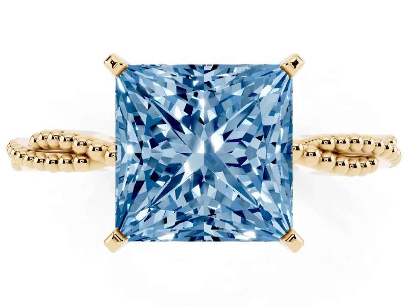 Fancy Blue Princess Cut Diamond Solitaire Ring Set in Yellow gold with Twisted Band and Bead Prong Setting
