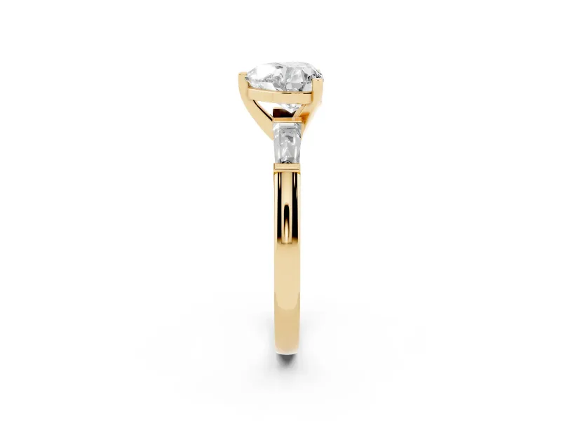Heart Cut Diamond Solitaire Ring Set in Yellow gold with Tapered Baguette Side Stones and Prong Setting