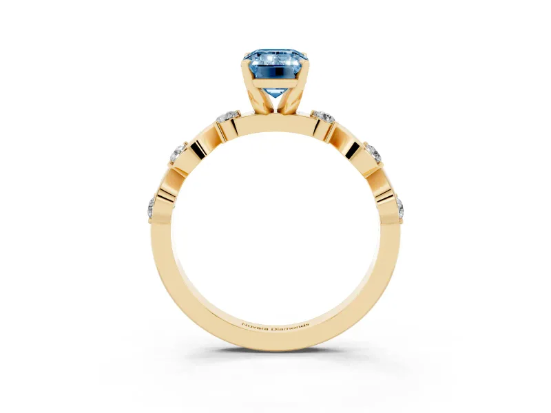 Fancy Blue Emerald Cut Diamond Solitaire Ring Set in Yellow gold with Ribbon Twist Band, Round Accents and Prong Setting