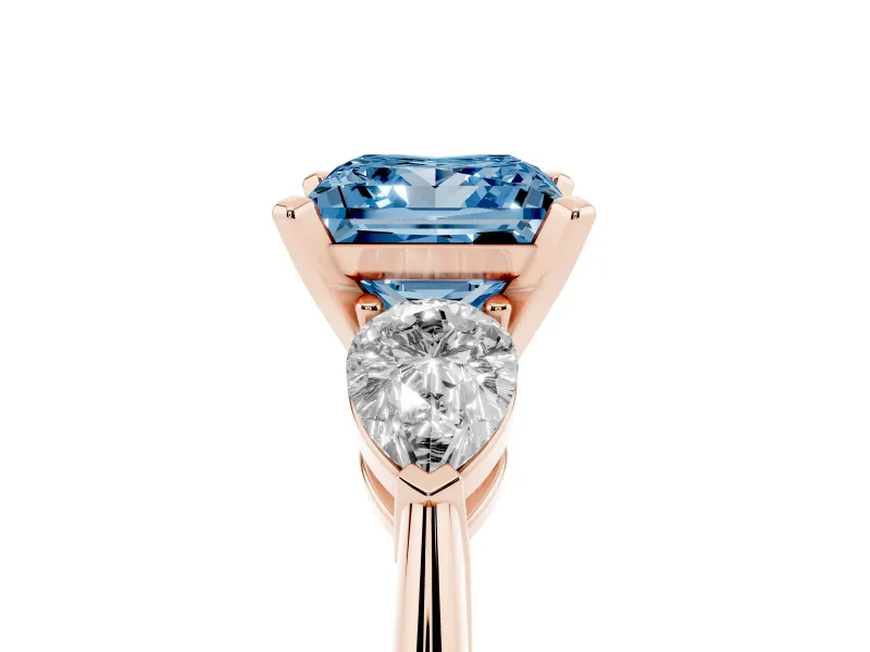 Fancy Blue Three-Stone Princess Cut Diamond Ring Set in Rose gold with Pear Side Stones and Prong Setting