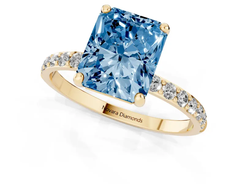 Fancy Blue Radiant Cut Diamond Solitaire Ring Set in Yellow gold with Round Pavé Band and Prong Setting
