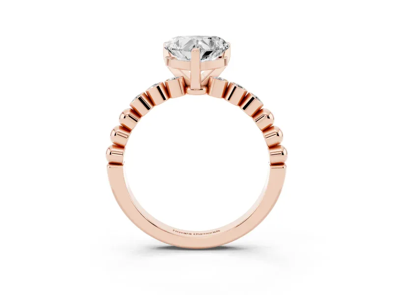 Heart Cut Diamond Solitaire Engagement Ring Set in Rose gold with Bezel Accents on Beaded Band