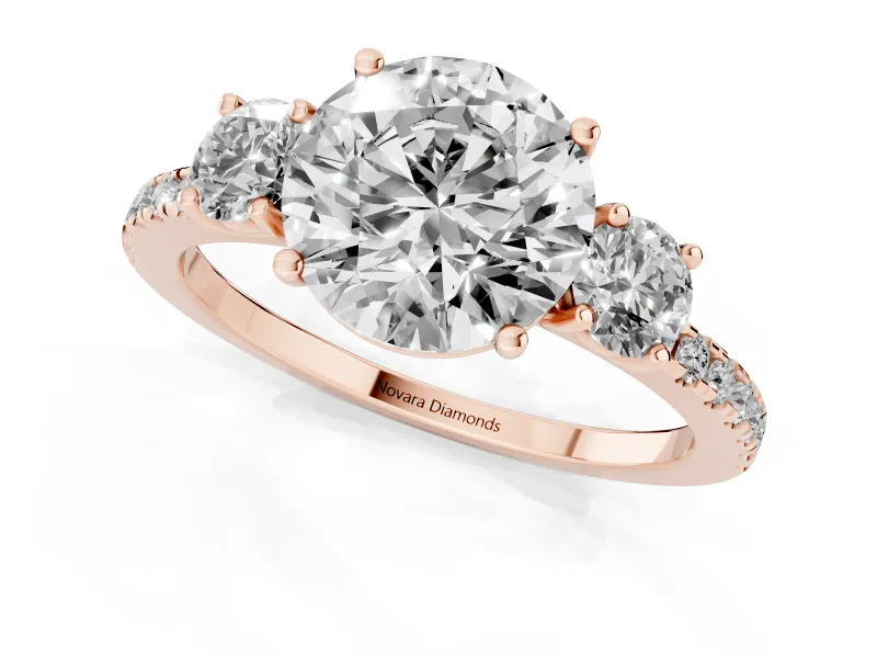 Round Cut Diamond Three-Stone Ring Set in Rose gold with Pavé Band and Graduated Sides