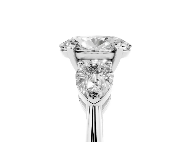 Three-Stone Oval Cut Diamond Ring Set in Platinum with Pear Side Stones and Prong Setting