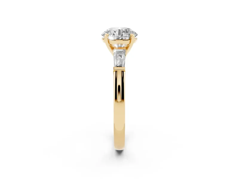 Round Cut Diamond Solitaire Ring Set in Yellow gold with Tapered Baguette Side Stones and Prong Setting