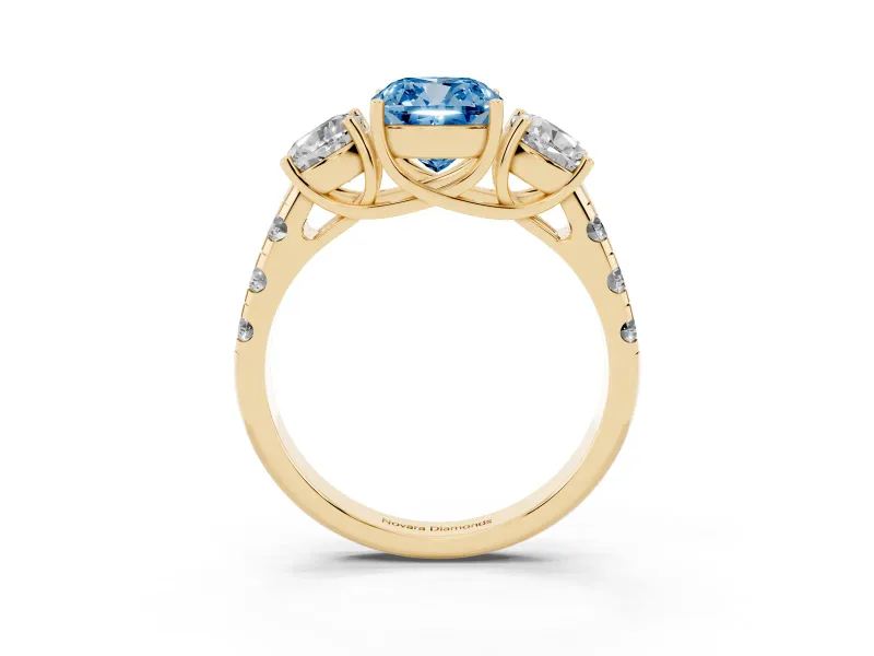Fancy Blue Cushion Cut Diamond Three-Stone Ring Set in Yellow gold with Pavé Band