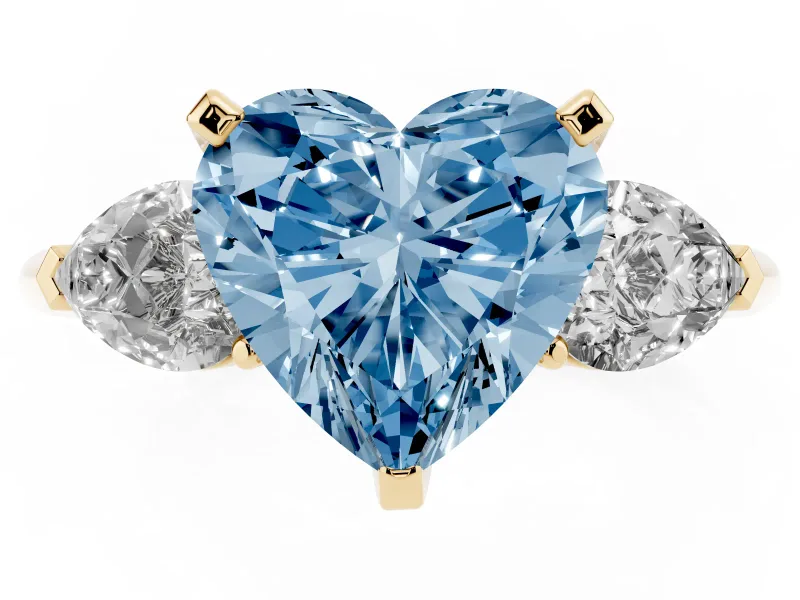 Fancy Blue Three-Stone Heart Cut Diamond Ring Set in Yellow gold with Pear Side Stones and Prong Setting