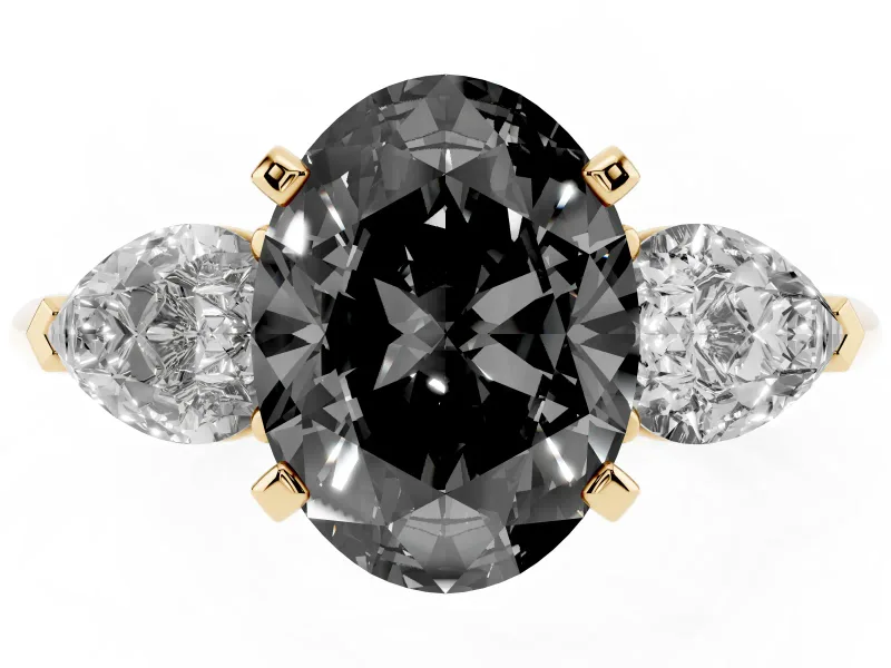 Fancy Black Three-Stone Oval Cut Diamond Ring Set in Yellow gold with Pear Side Stones and Prong Setting