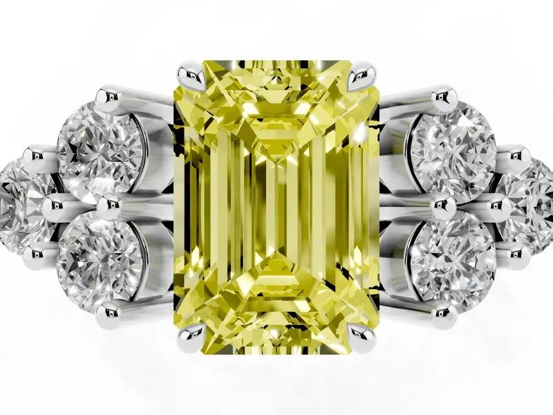 Fancy Yellow Emerald Cut Diamond Solitaire Ring Set in White gold with Cluster Accents on Each Side