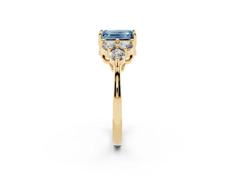 Fancy Blue Emerald Cut Diamond Solitaire Ring Set in Yellow gold with Cluster Accents on Each Side