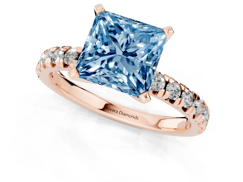 Fancy Blue Princess Cut Diamond Solitaire Pavé Engagement Ring Set in Rose gold with Round Band and Prong Setting