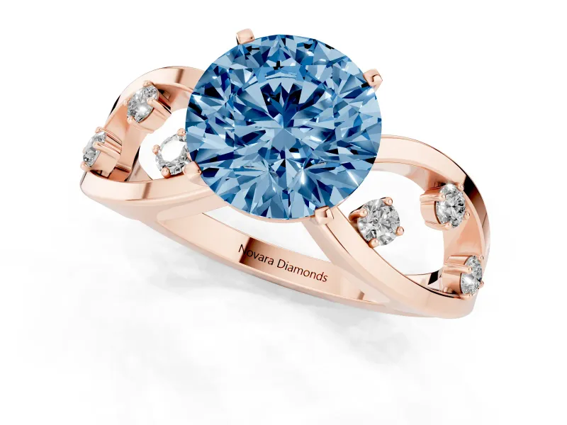 Fancy Blue Round Cut Diamond Solitaire Ring Set in Rose gold with Side Stones on Criss-Cross Band and Prong Setting