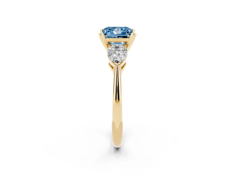 Fancy Blue Three-Stone Princess Cut Diamond Ring Set in Yellow gold with Pear Side Stones and Prong Setting