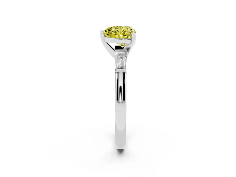 Fancy Yellow Heart Cut Diamond Solitaire Ring Set in White gold with Tapered Baguette Side Stones and Prong Setting