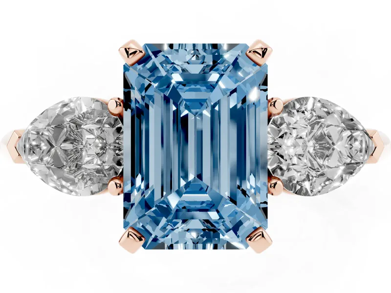 Fancy Blue Three-Stone Emerald Cut Diamond Ring Set in Rose gold with Pear Side Stones and Prong Setting