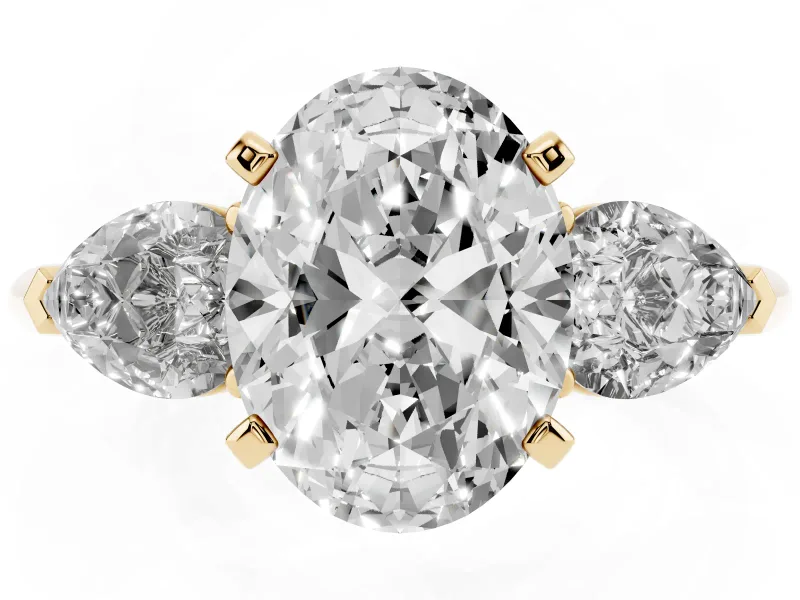 Three-Stone Oval Cut Diamond Ring Set in Yellow gold with Pear Side Stones and Prong Setting