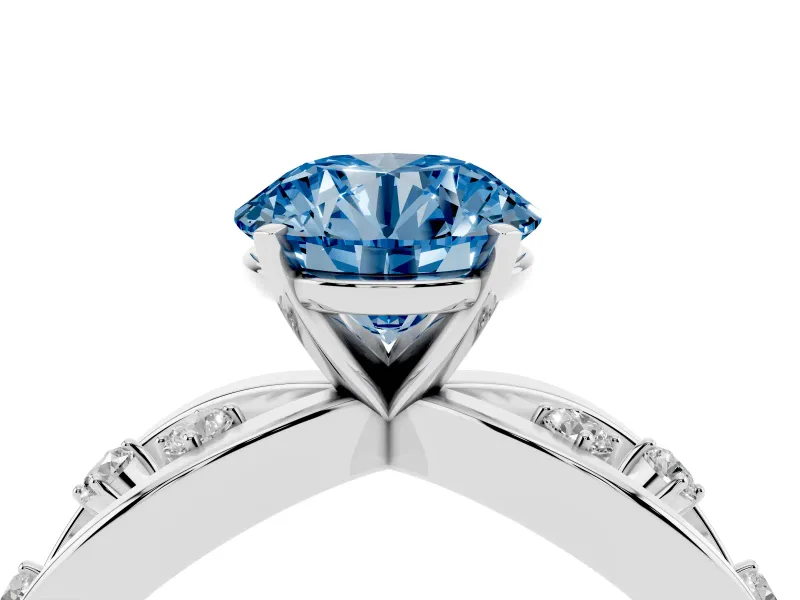 Fancy Blue Round Cut Diamond Solitaire Ring Set in Silver with Side Stones on Criss-Cross Band and Prong Setting