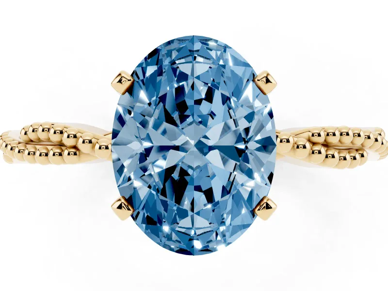 Fancy Blue Oval Cut Diamond Solitaire Ring Set in Yellow gold with Twisted Band and Bead Prong Setting