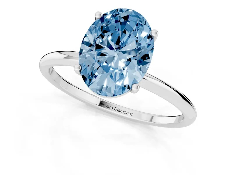 Fancy Blue Oval Cut Diamond Solitaire Engagement Ring Set in Silver with Thin Band and Prong Setting