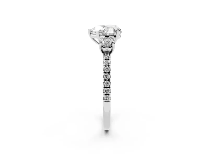 Heart Cut Diamond Three-Stone Ring Set in White gold with Pavé Band and Graduated Sides